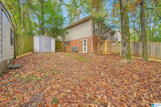 view of yard featuring central AC and a shed