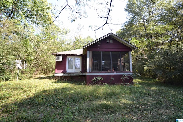 rear view of property featuring a sunroom