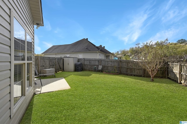 view of yard with a shed and a patio