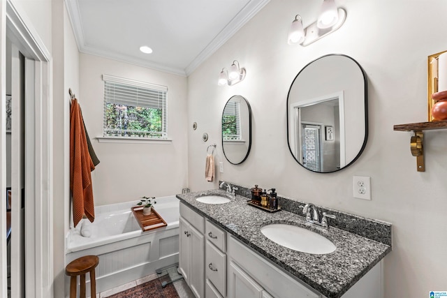 bathroom with a washtub, vanity, and ornamental molding