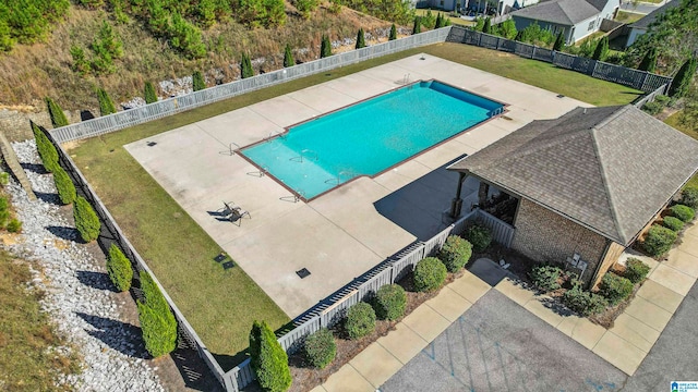 view of pool featuring a patio and a lawn