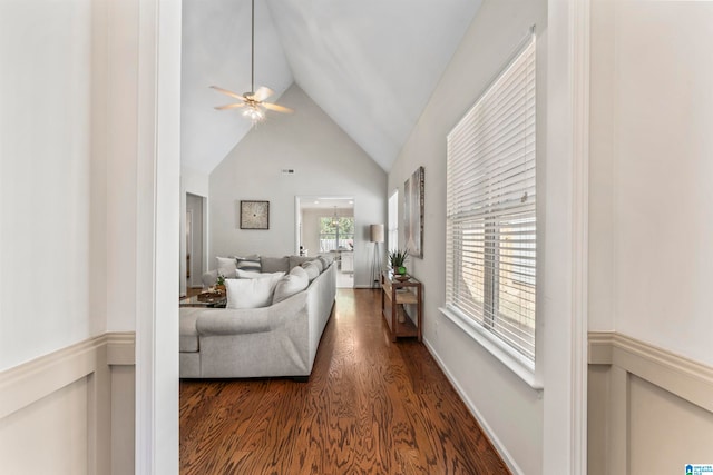 living room featuring high vaulted ceiling, dark wood-type flooring, and ceiling fan