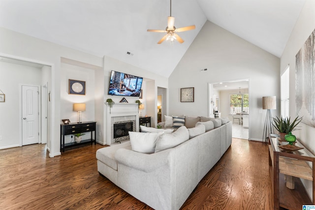 living room with ceiling fan, high vaulted ceiling, and dark hardwood / wood-style flooring