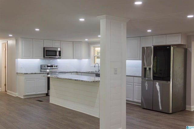 kitchen featuring white cabinetry, stainless steel appliances, and dark wood-type flooring