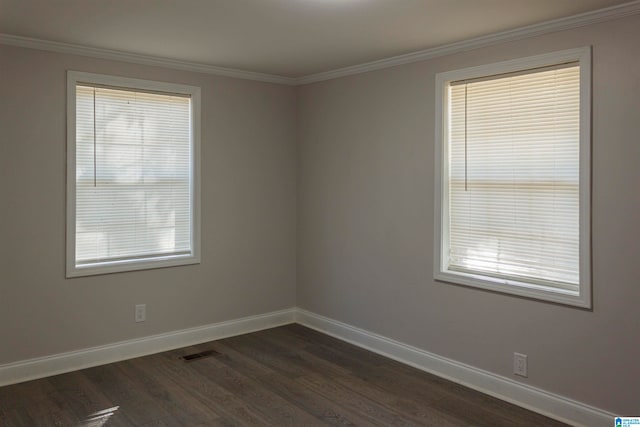 spare room featuring crown molding and dark hardwood / wood-style flooring