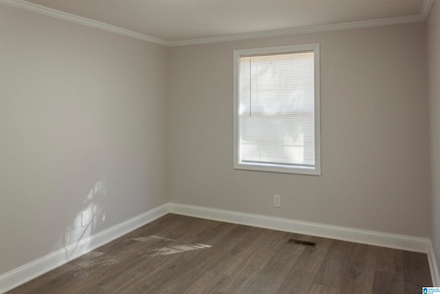 spare room featuring crown molding, a healthy amount of sunlight, and dark hardwood / wood-style floors