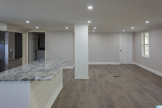 basement with hardwood / wood-style floors, stainless steel fridge with ice dispenser, washer / clothes dryer, and ornamental molding