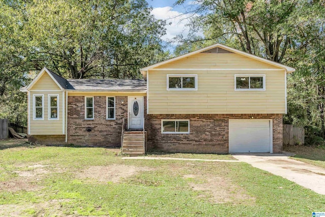 split level home featuring a garage and a front lawn