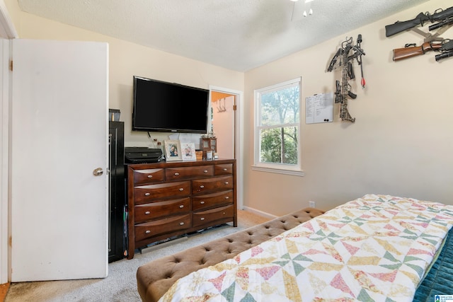 carpeted bedroom with a textured ceiling and ceiling fan