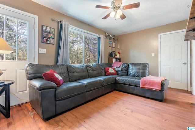 living room featuring hardwood / wood-style floors and ceiling fan