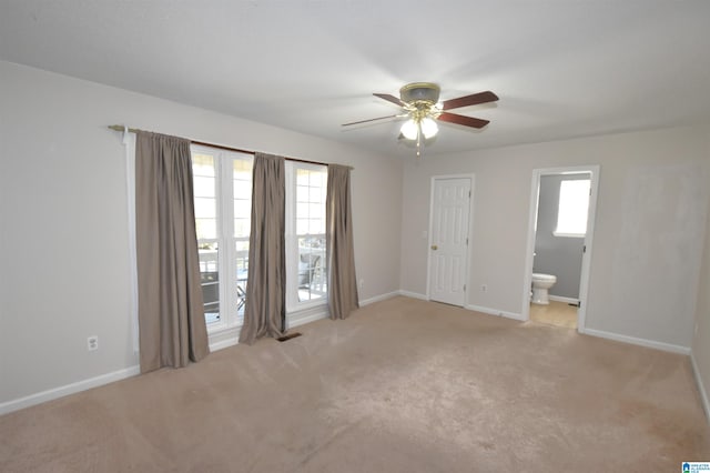 carpeted spare room with ceiling fan and a healthy amount of sunlight