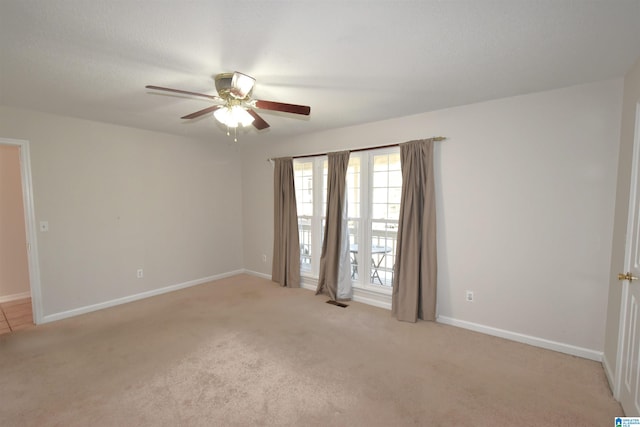 carpeted empty room with ceiling fan