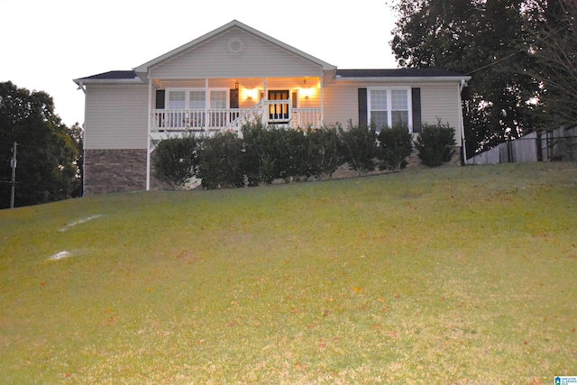 single story home with a porch and a front lawn