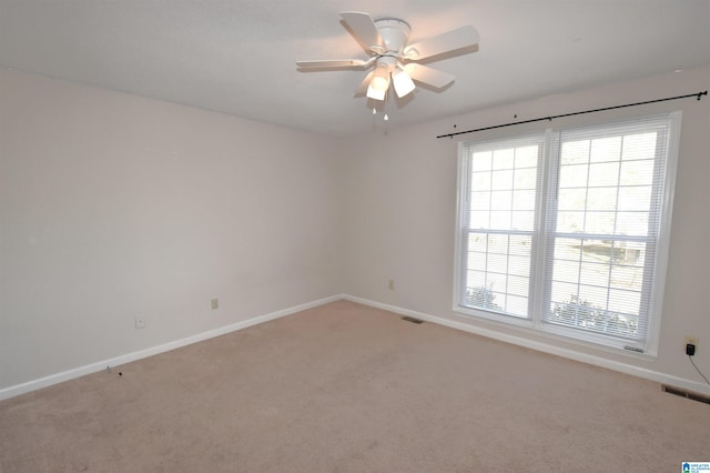 carpeted spare room with ceiling fan