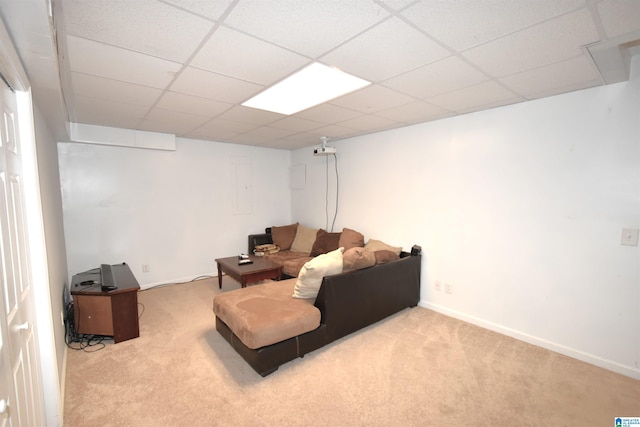 carpeted living room with a drop ceiling