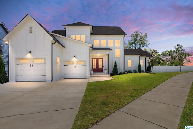 modern inspired farmhouse featuring french doors and a yard