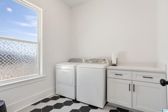 laundry room with cabinets, plenty of natural light, and washer and clothes dryer