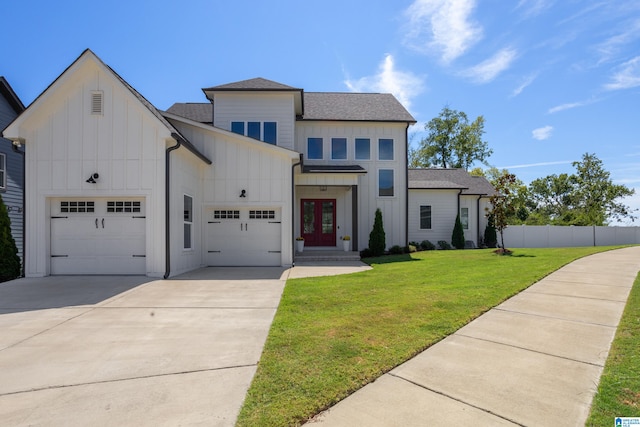 view of front facade featuring french doors, a front lawn, and a garage