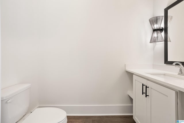 bathroom featuring hardwood / wood-style flooring, vanity, and toilet