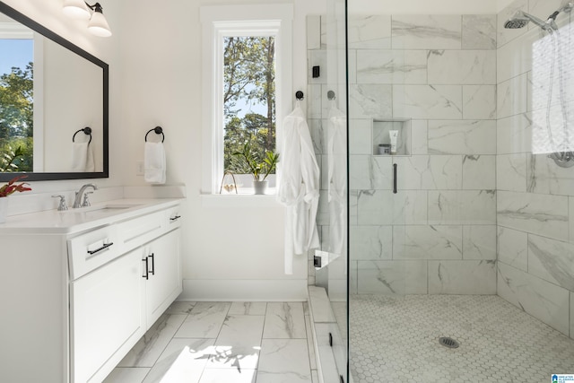 bathroom with a shower with door and vanity