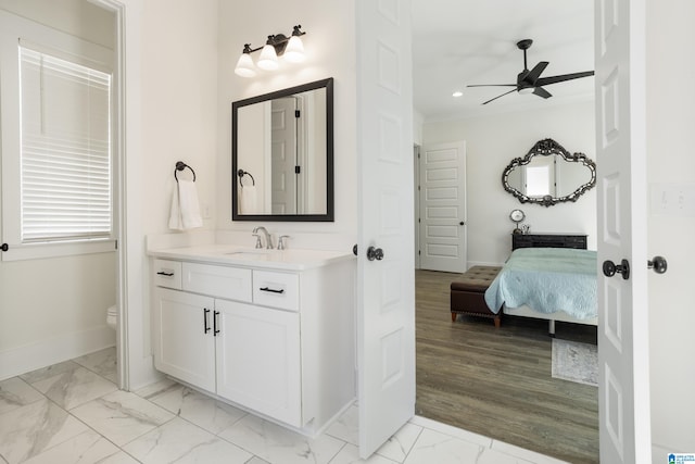 bathroom with hardwood / wood-style floors, ceiling fan, vanity, and toilet