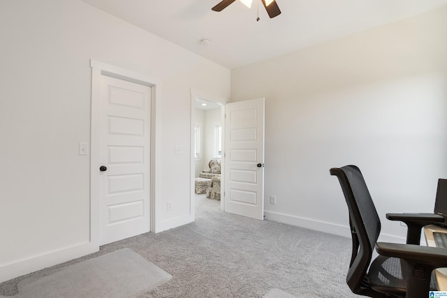 carpeted home office with ceiling fan