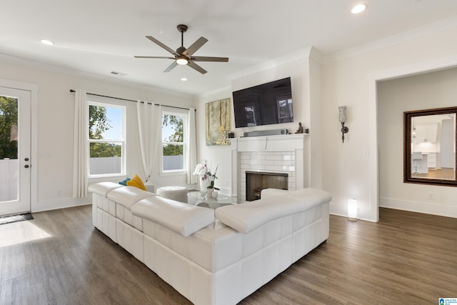 living room featuring ornamental molding, a wealth of natural light, and dark hardwood / wood-style flooring