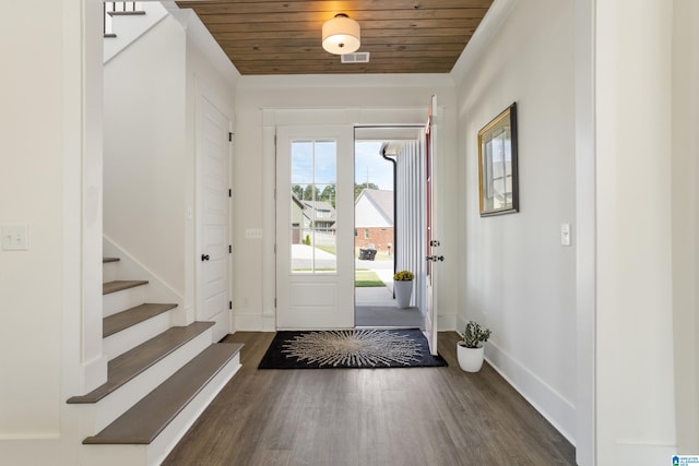 foyer with dark wood-type flooring, crown molding, and wooden ceiling