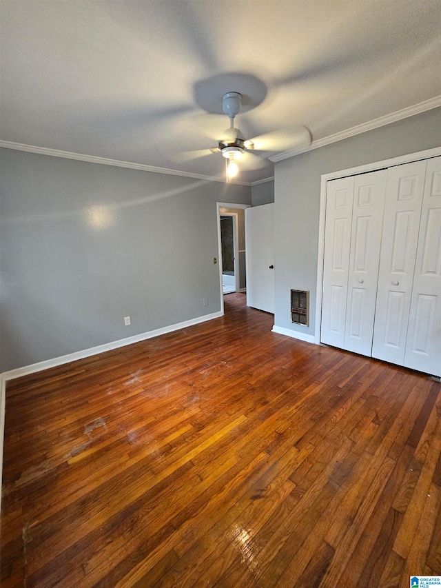 unfurnished bedroom featuring a closet, ceiling fan, dark hardwood / wood-style flooring, and crown molding