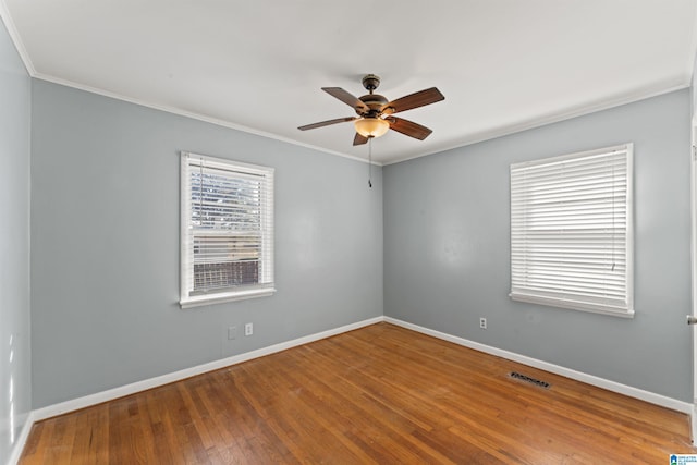 unfurnished room featuring hardwood / wood-style flooring, ceiling fan, and crown molding