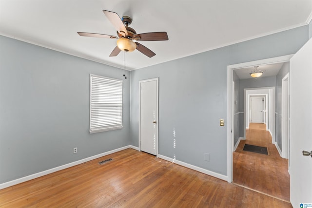 unfurnished bedroom featuring hardwood / wood-style flooring and ceiling fan