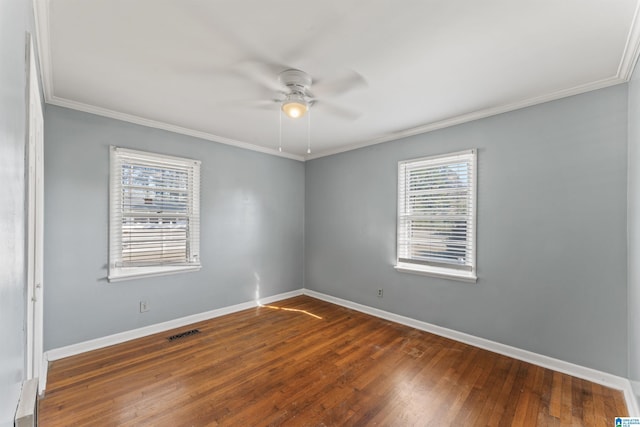 unfurnished room featuring crown molding, dark hardwood / wood-style flooring, ceiling fan, and a healthy amount of sunlight