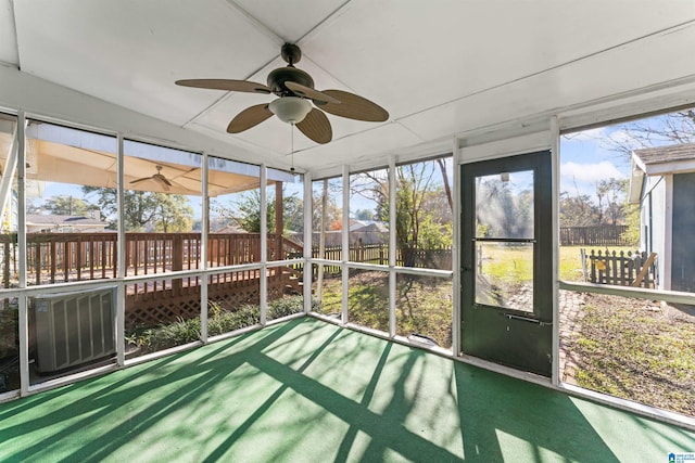 unfurnished sunroom featuring ceiling fan