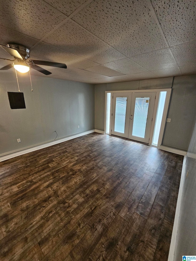 empty room featuring ceiling fan, a drop ceiling, french doors, and hardwood / wood-style flooring