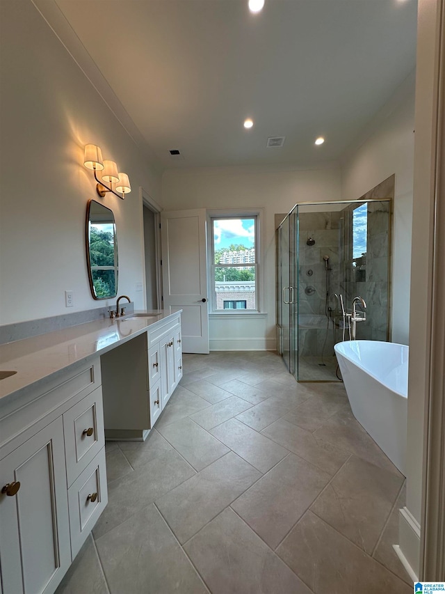 bathroom with tile patterned floors, vanity, and separate shower and tub