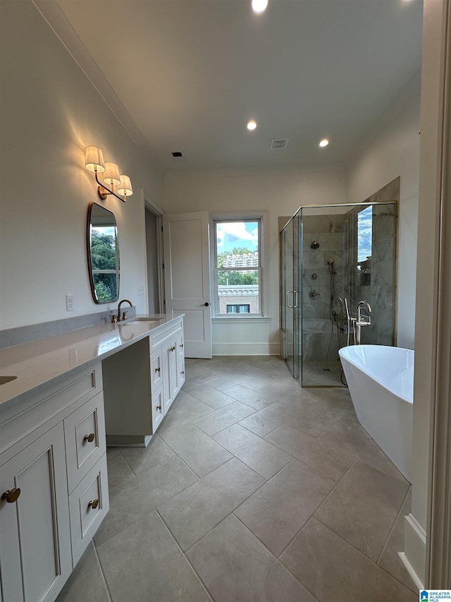 1227 23rd St S Unit B2, Birmingham, AL 35205 - bathroom with double vanity, a stall shower, recessed lighting, a freestanding tub, and tile patterned floors