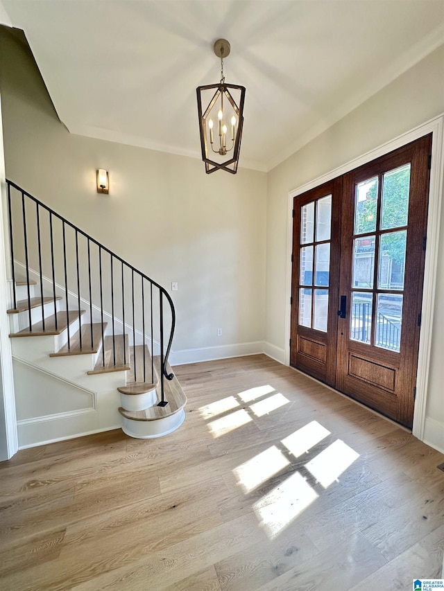 1227 23rd St S Unit B2, Birmingham, AL 35205 - foyer entrance featuring french doors, wood finished floors, baseboards, and a chandelier