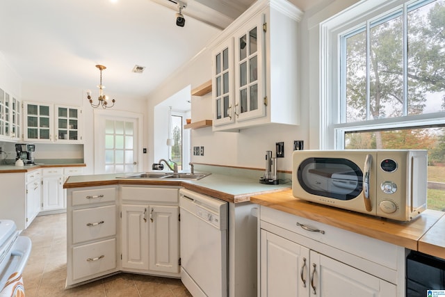 kitchen featuring dishwasher, an inviting chandelier, decorative light fixtures, and white cabinets