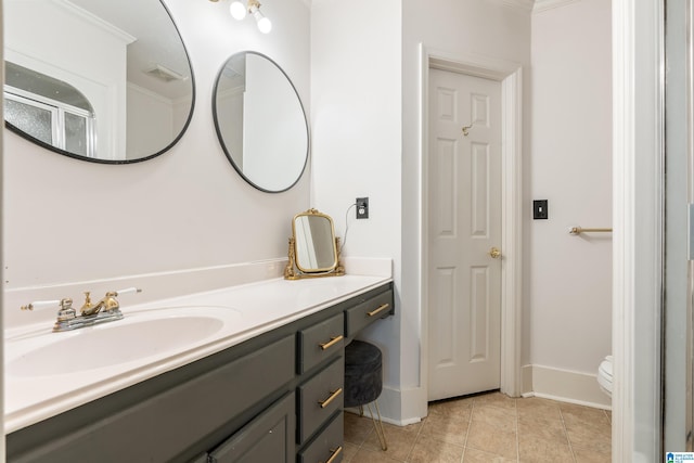 bathroom with tile patterned floors, ornamental molding, vanity, toilet, and a shower with shower door