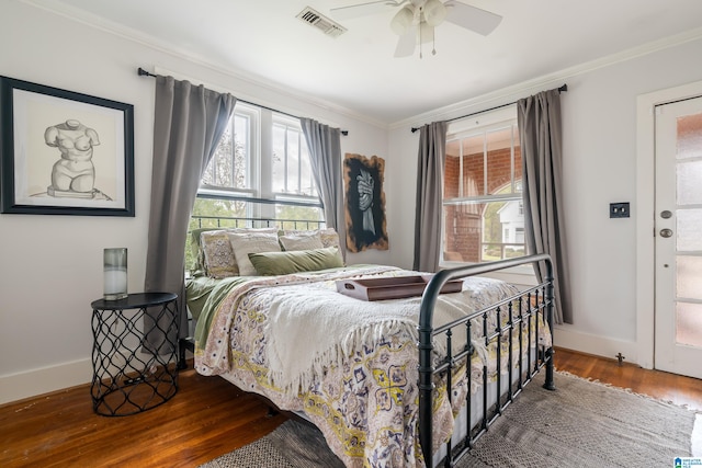 bedroom featuring hardwood / wood-style flooring, ceiling fan, and ornamental molding