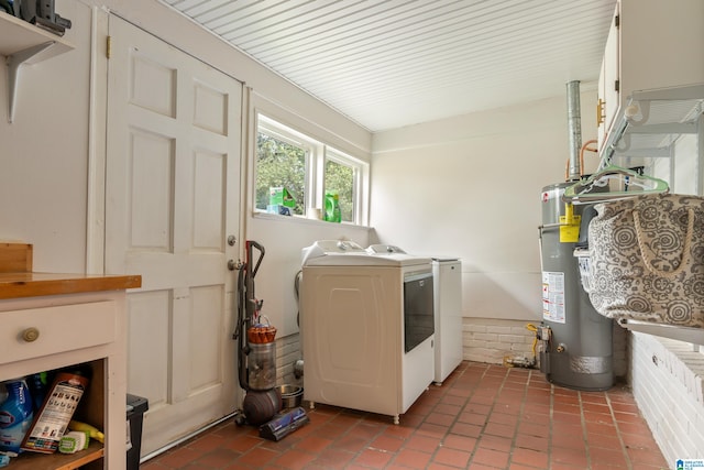 laundry area featuring water heater and washing machine and clothes dryer