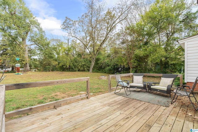 wooden terrace featuring a yard