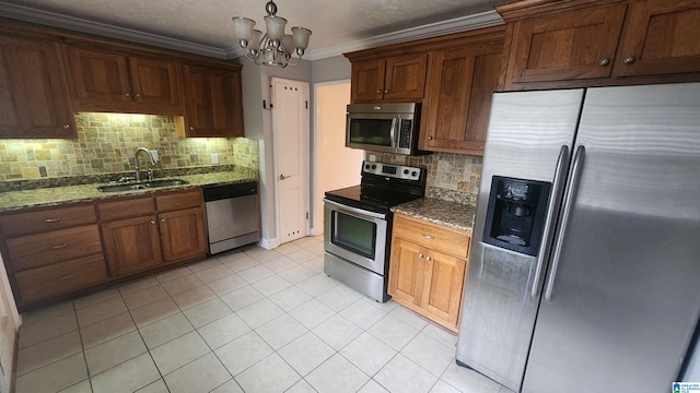 kitchen with decorative backsplash, appliances with stainless steel finishes, dark stone counters, sink, and an inviting chandelier