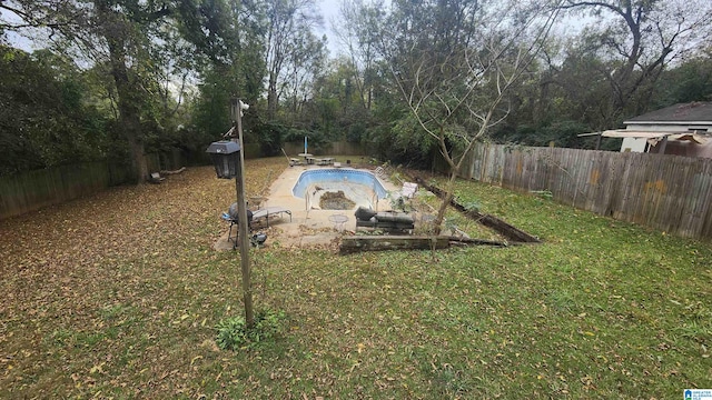 view of yard with a patio area and a fenced in pool