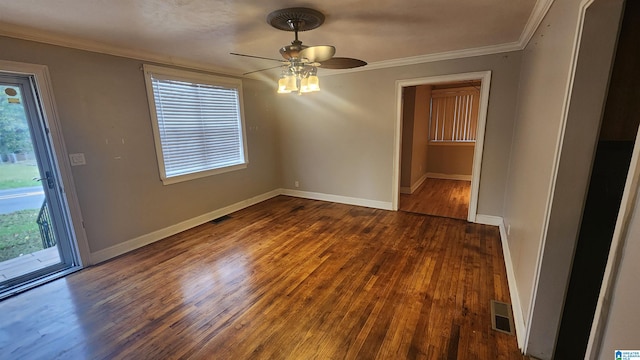 spare room with dark hardwood / wood-style floors, ceiling fan, and a healthy amount of sunlight