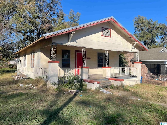 bungalow-style home with a front yard and a porch