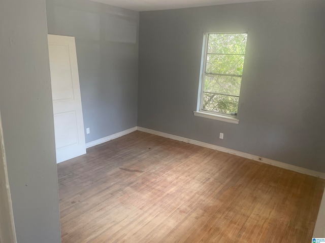 spare room with hardwood / wood-style floors