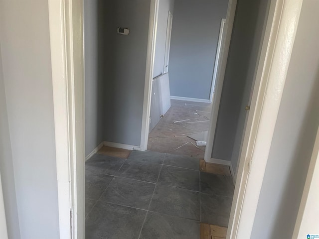 corridor featuring dark tile patterned floors