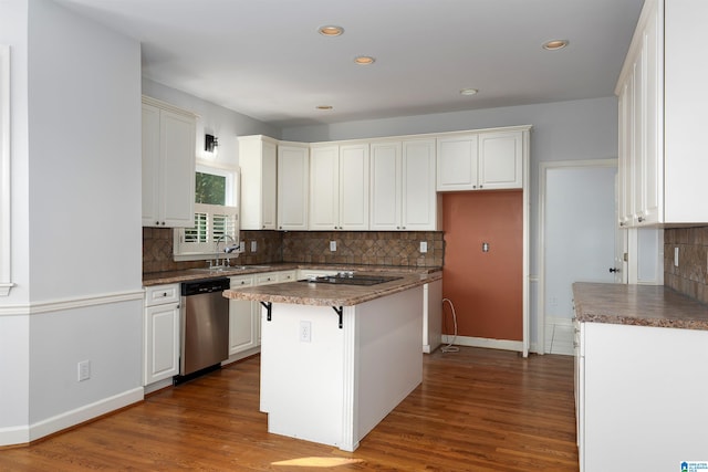 kitchen with dark hardwood / wood-style flooring, stainless steel dishwasher, sink, a center island, and white cabinetry