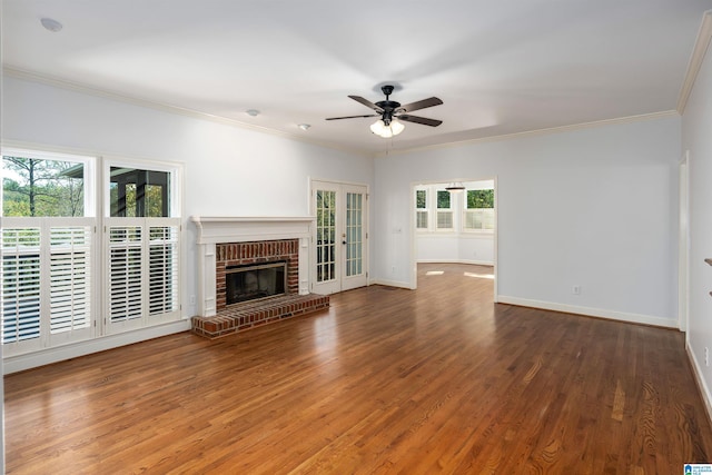 unfurnished living room with dark wood-type flooring, a healthy amount of sunlight, french doors, and ornamental molding